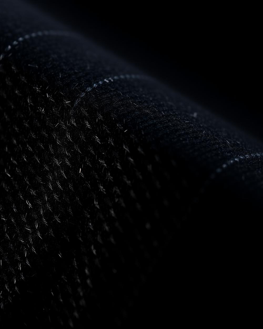 Macro detail of wool weave and stitching